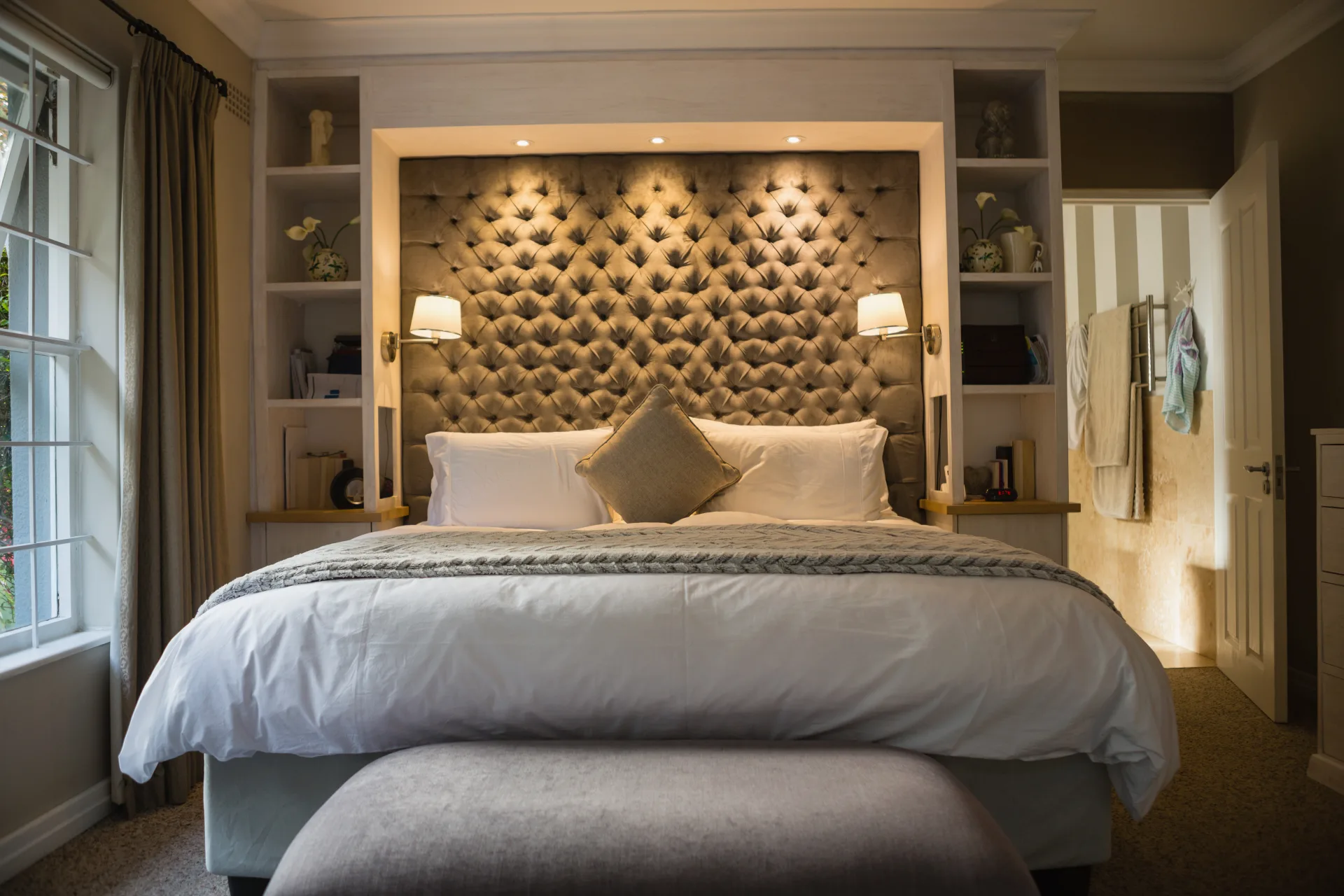 Elegant bedroom with a tufted headboard and a turned-down bed