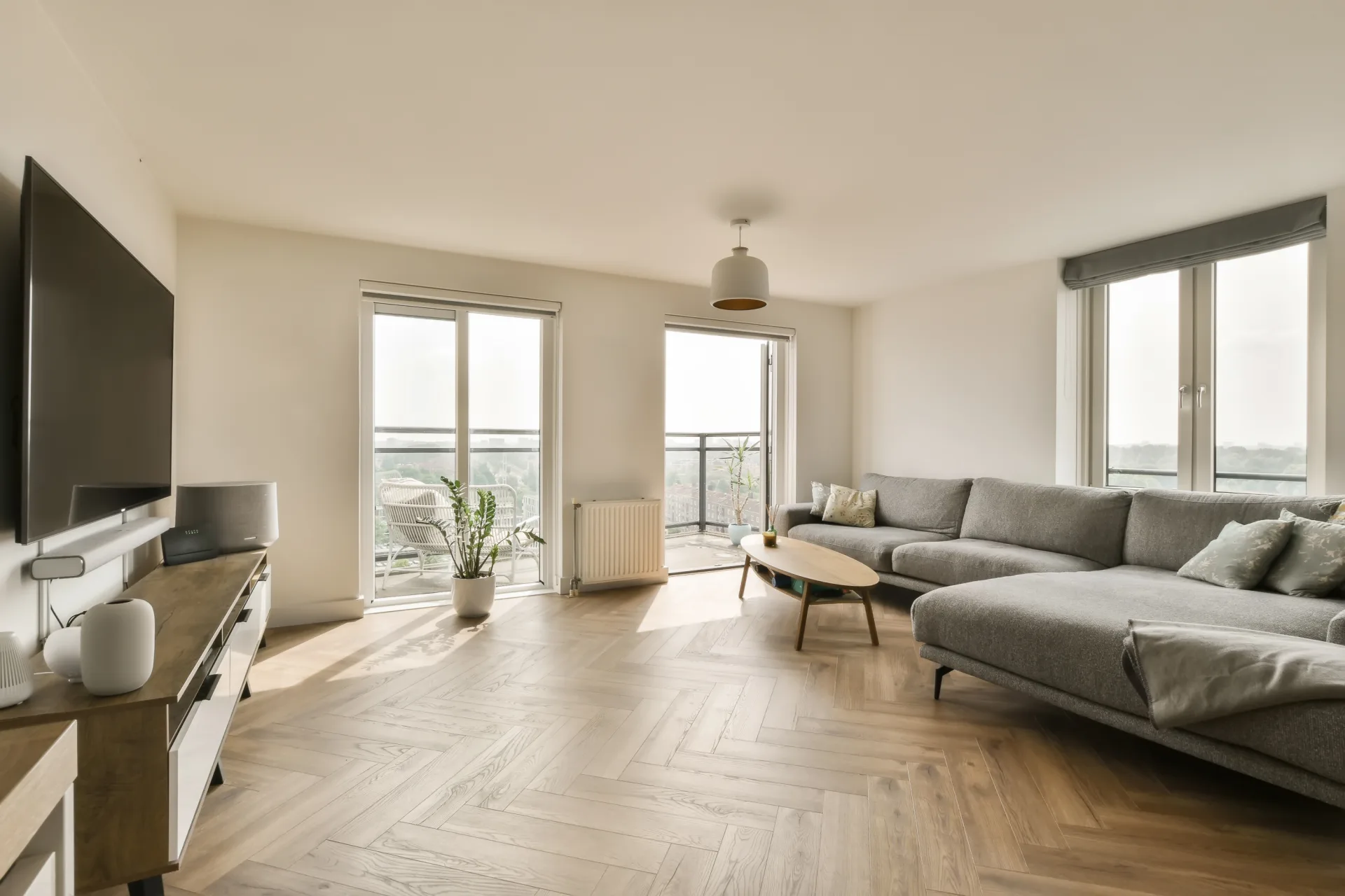 Bright living room with herringbone floors and balcony doors